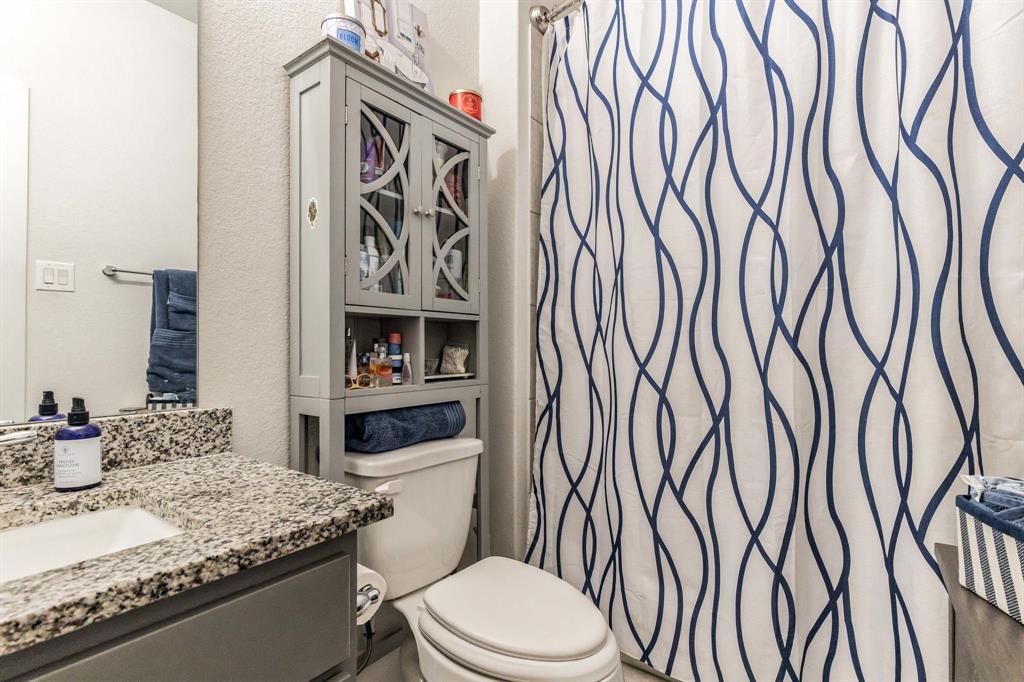 325 Cumberland Cove Georgetown, TX 78628 - Photo 24 of 39 a bathroom with a granite countertop sink and a toilet