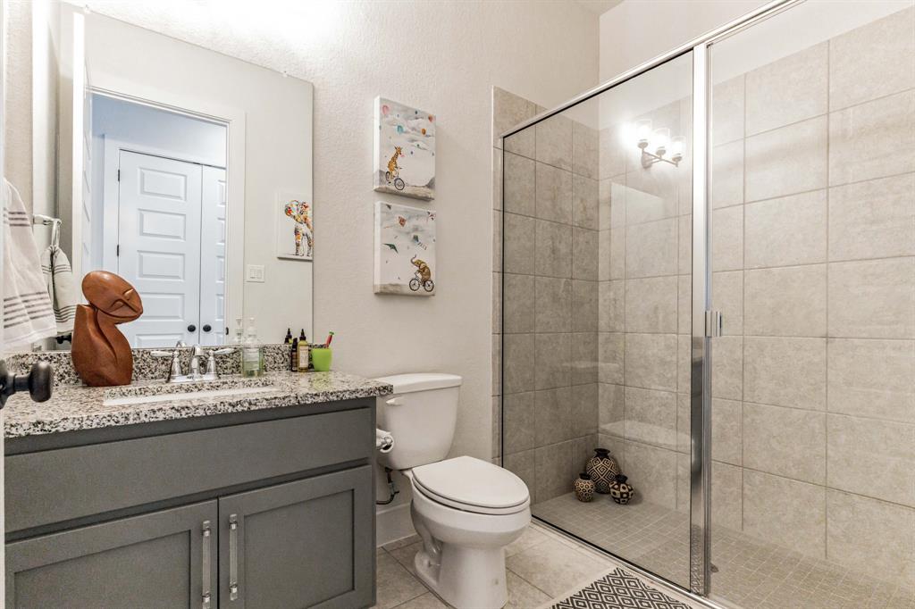 325 Cumberland Cove Georgetown, TX 78628 - Photo 28 of 39 a bathroom with a granite countertop sink toilet and shower
