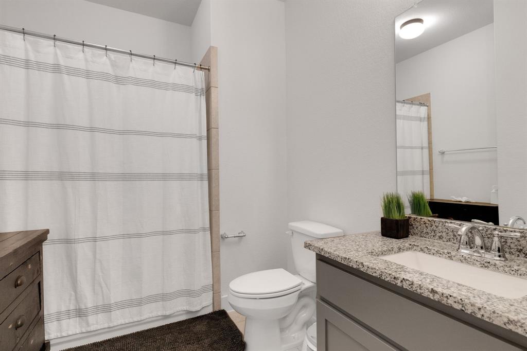 325 Cumberland Cove Georgetown, TX 78628 - Photo 30 of 39 a bathroom with a granite countertop sink toilet and shower
