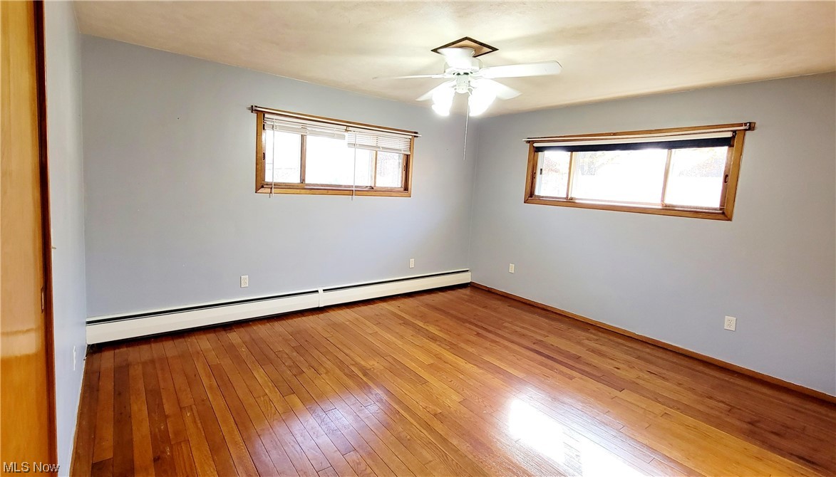 405 Bryan Road Milan, OH 44846 - Photo 13 of 35 Bedroom with ceiling fan, wood flooring, and a baseboard heating unit
