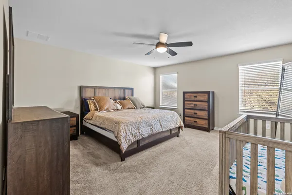 a bedroom with a bed a window and closet