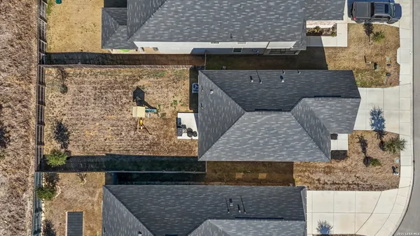 an aerial view of residential houses with outdoor space