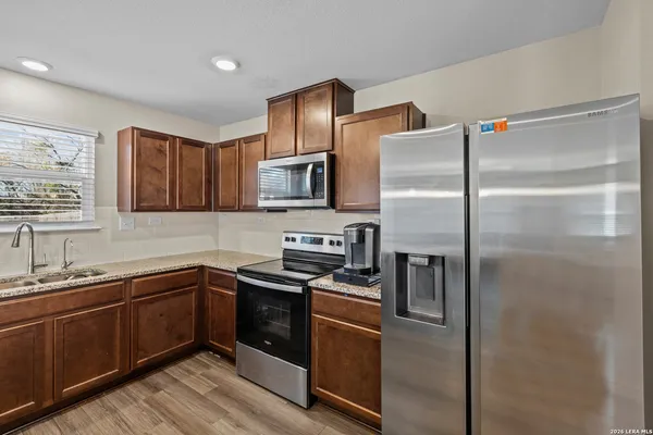 a kitchen with a refrigerator sink and microwave