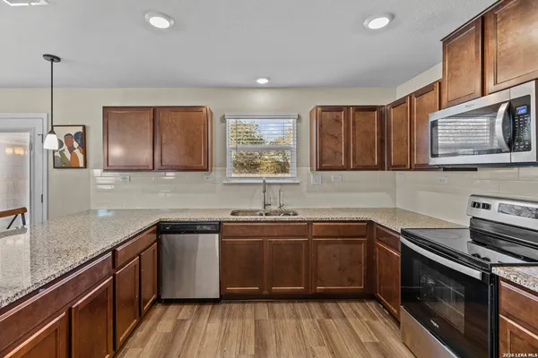 a kitchen with a sink stove and cabinets