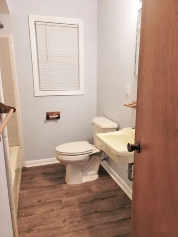 a white toilet sitting next to a bathroom sink
