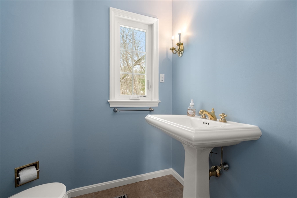 173 Conant Road Weston, MA 02493 - Photo 12 of 25 a bathroom with a sink a toilet and a mirror