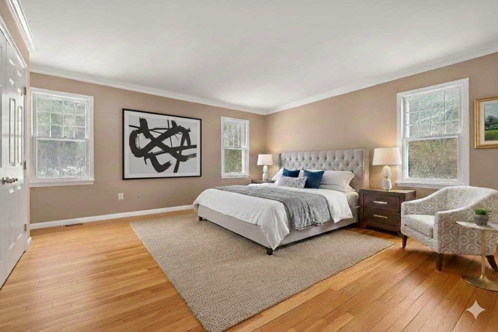 173 Conant Road Weston, MA 02493 - Photo 14 of 25 a bedroom with a large bed wooden floor and window
