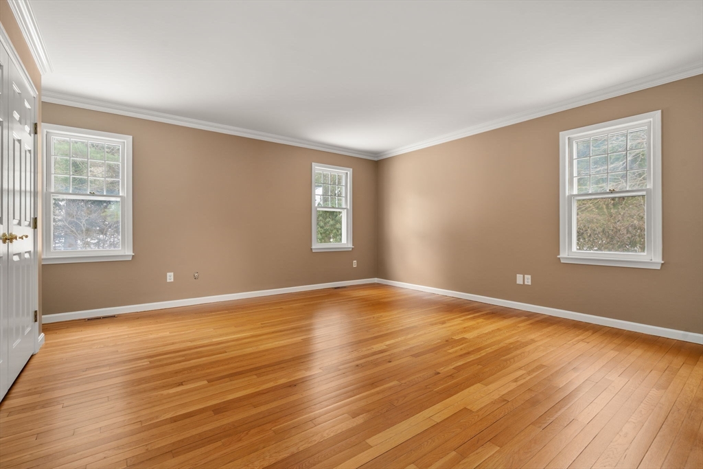 173 Conant Road Weston, MA 02493 - Photo 15 of 25 a view of an empty room with wooden floor and a window