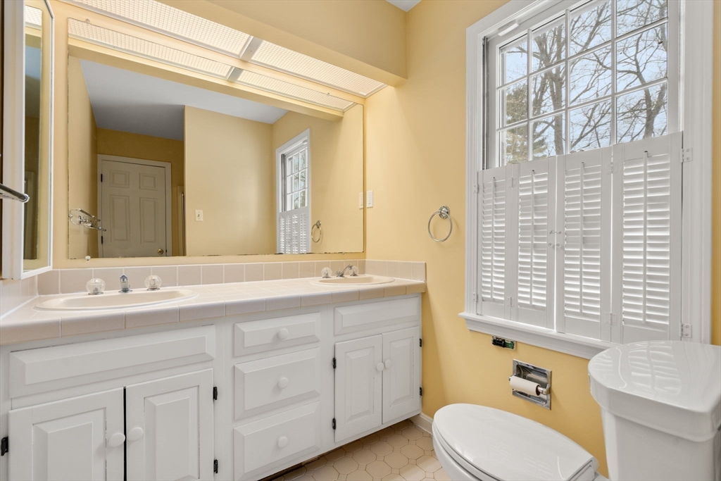 173 Conant Road Weston, MA 02493 - Photo 16 of 25 a bathroom with a double vanity sink toilet mirror and bathtub