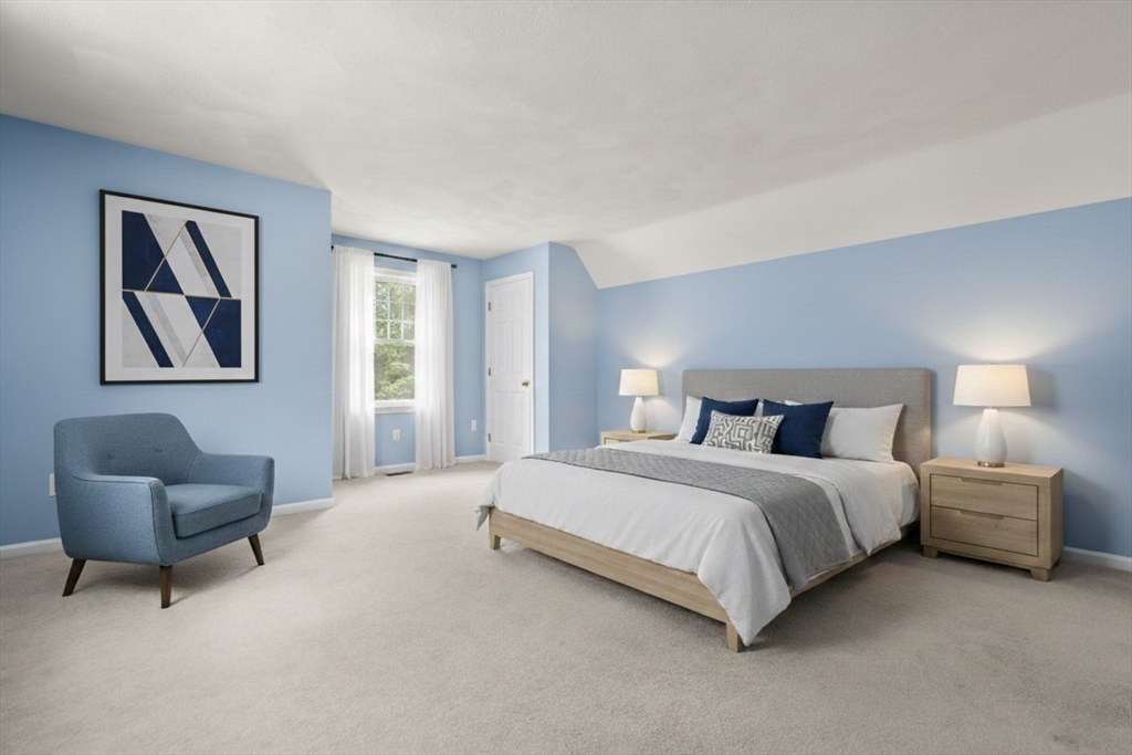 173 Conant Road Weston, MA 02493 - Photo 17 of 25 a spacious bedroom with a bed and a couch