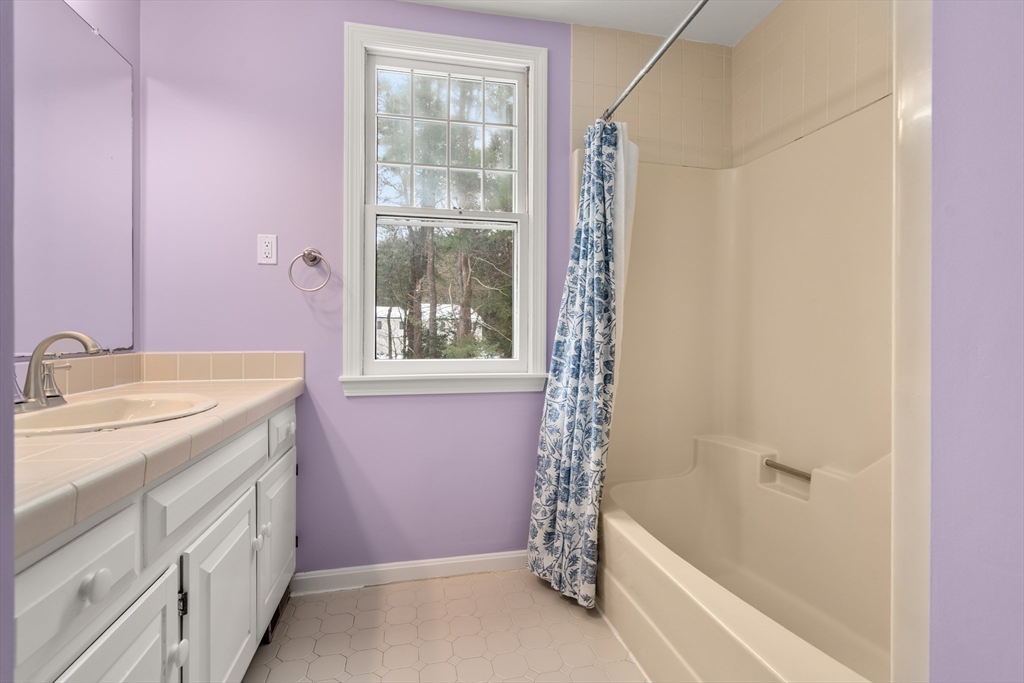 173 Conant Road Weston, MA 02493 - Photo 20 of 25 a bathroom with a granite countertop sink a shower and a bathtub