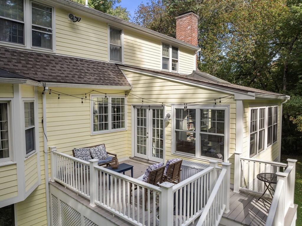 173 Conant Road Weston, MA 02493 - Photo 23 of 25 a view of a house with a large window and wooden fence