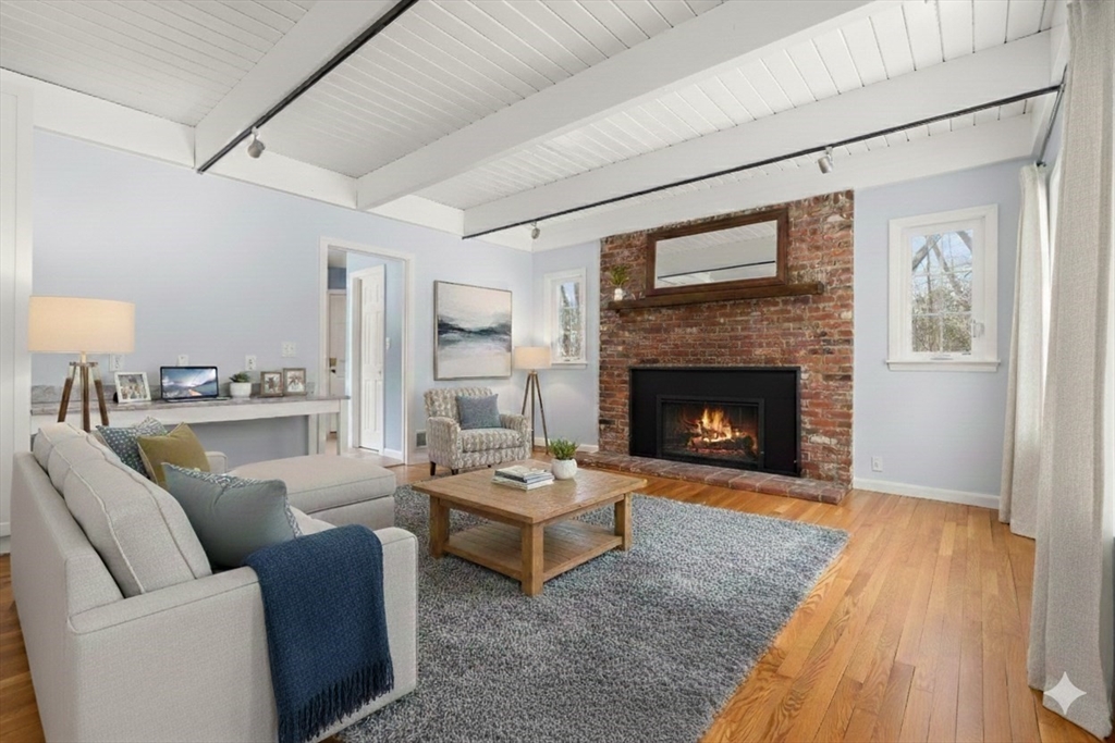 173 Conant Road Weston, MA 02493 - Photo 4 of 25 a living room with furniture and a fireplace