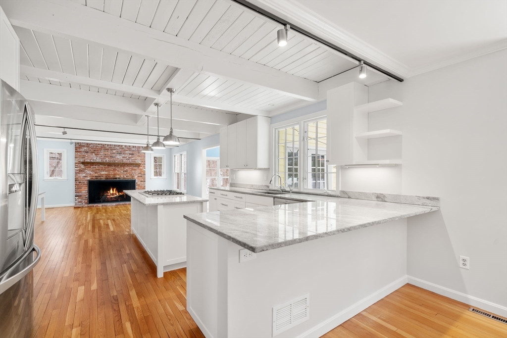 173 Conant Road Weston, MA 02493 - Photo 5 of 25 a kitchen with kitchen island a stove a sink and a wooden floors