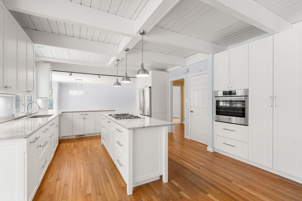 173 Conant Road Weston, MA 02493 - Photo 6 of 25 a kitchen with granite countertop white cabinets and white appliances