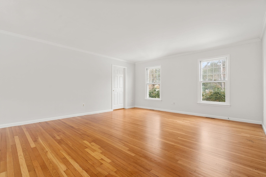 173 Conant Road Weston, MA 02493 - Photo 10 of 25 an empty room with wooden floor and windows