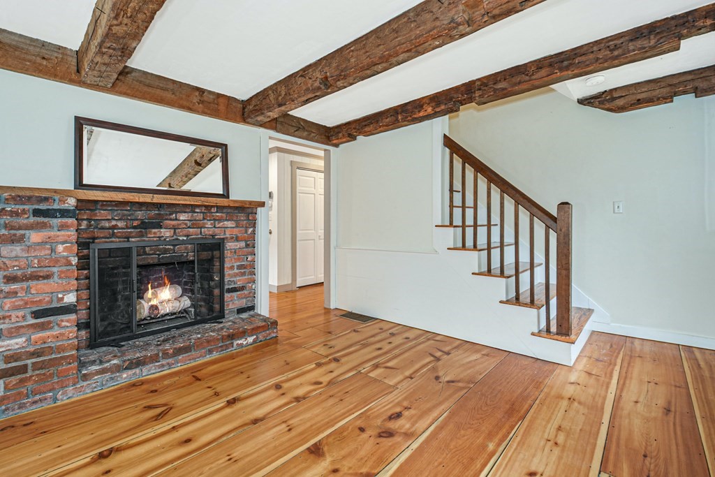 30 Nourse Road Bolton, MA 01740 - Photo 17 of 40 a view of an empty room with wooden floor fireplace and a window