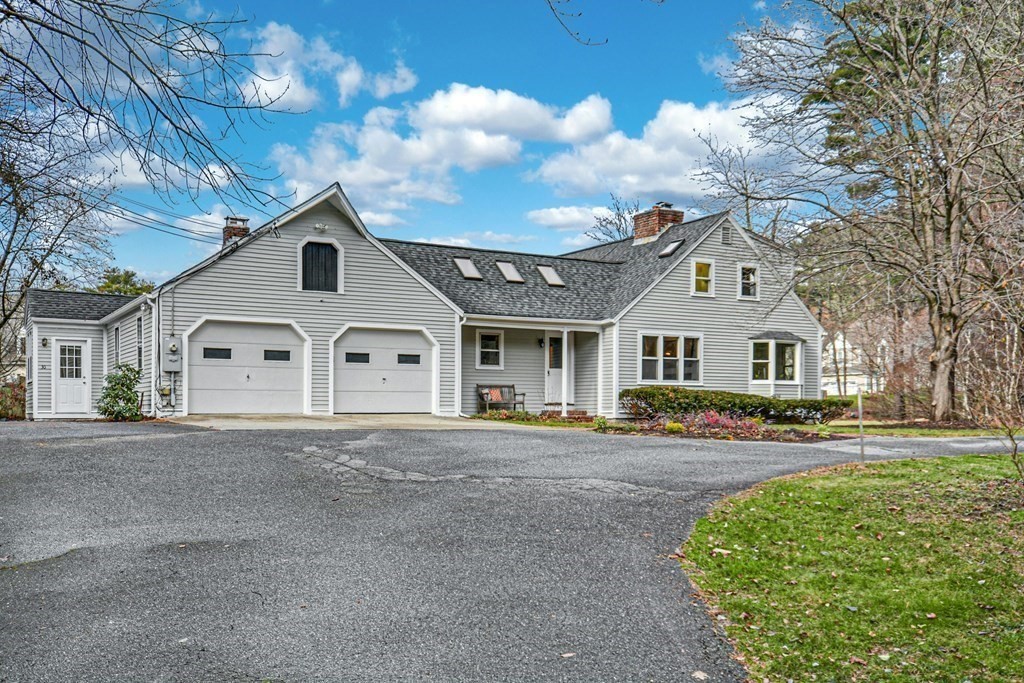 30 Nourse Road Bolton, MA 01740 - Photo 2 of 40 a front view of a house with a garden and trees