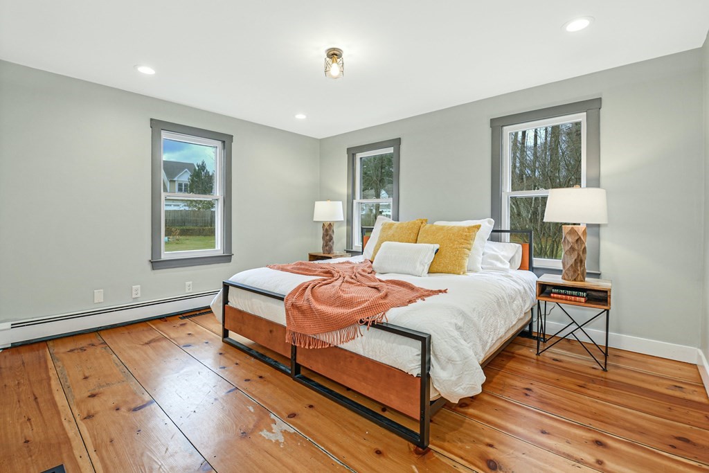 30 Nourse Road Bolton, MA 01740 - Photo 21 of 40 a bedroom with a bed lamp closet and window