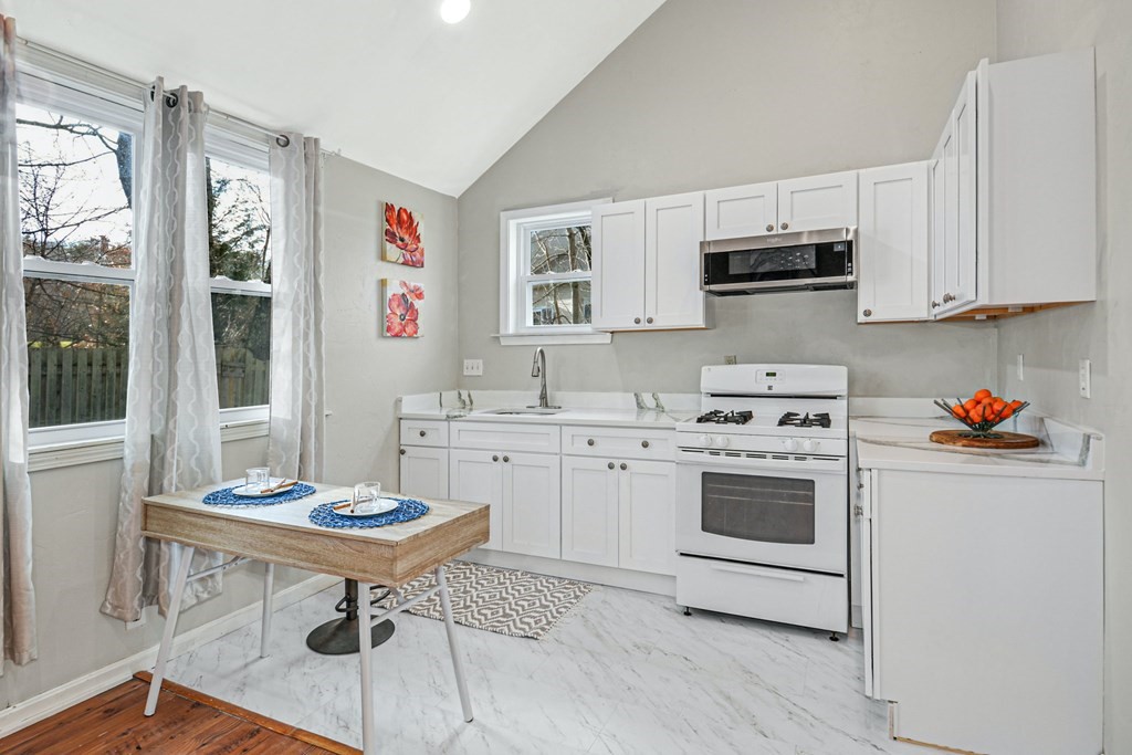 30 Nourse Road Bolton, MA 01740 - Photo 32 of 40 a kitchen with granite countertop a sink appliances and cabinets