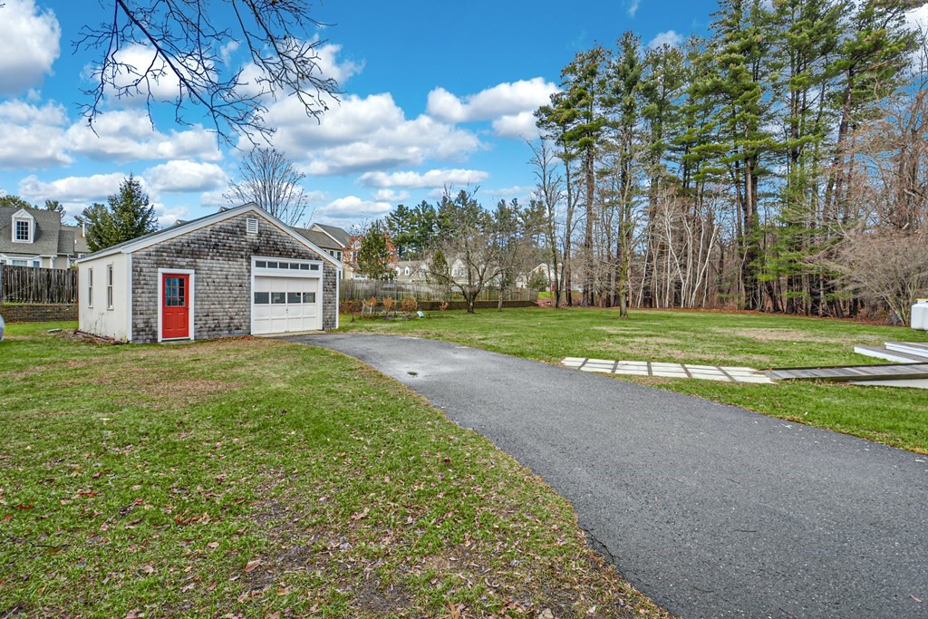 30 Nourse Road Bolton, MA 01740 - Photo 6 of 40 a front view of a house with a garden and yard
