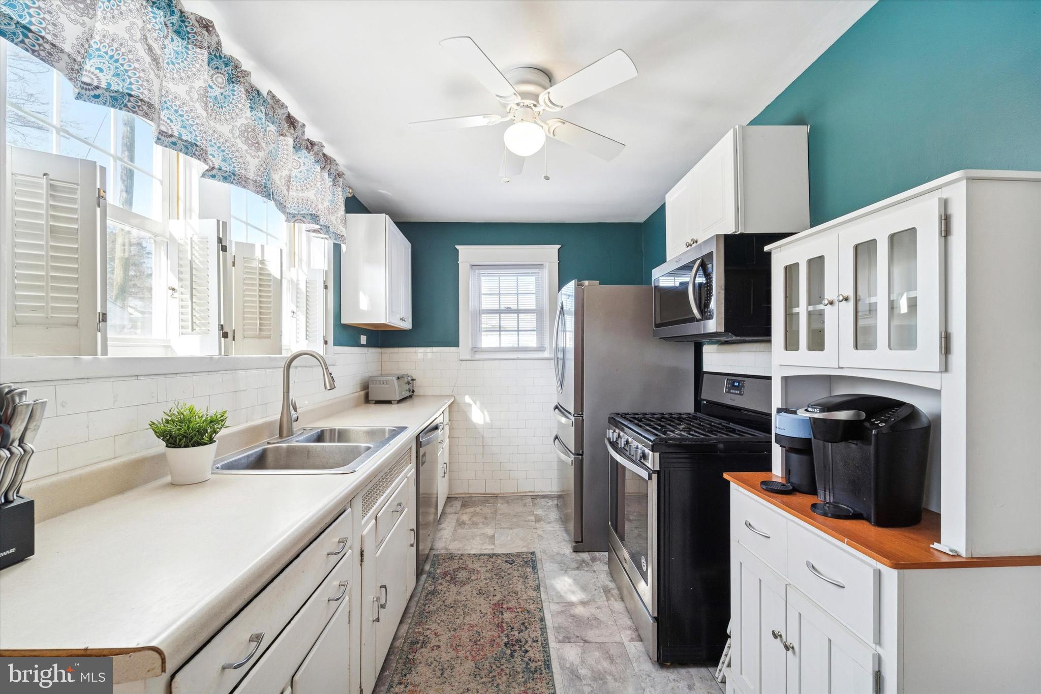 208 Harwicke Road Springfield, PA 19064 - Photo 10 of 25 a kitchen with stainless steel appliances granite countertop a sink stove and refrigerator