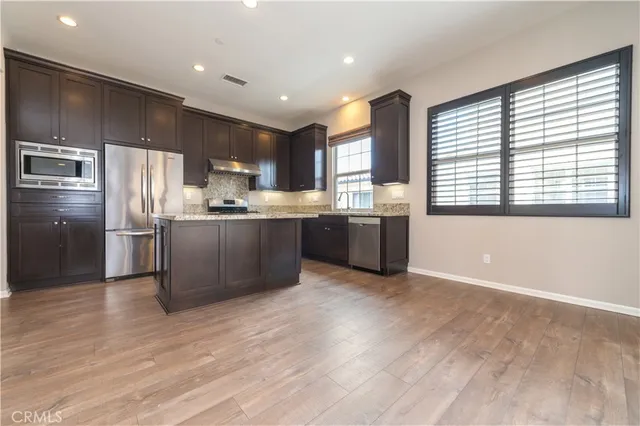 a view of kitchen and hall with wooden floor