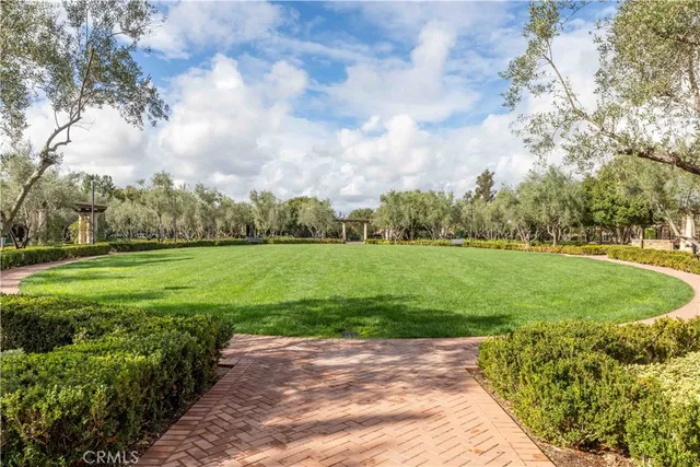 a view of a house with a yard and potted plants