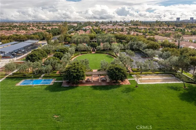 an aerial view of residential houses with outdoor space and lake view