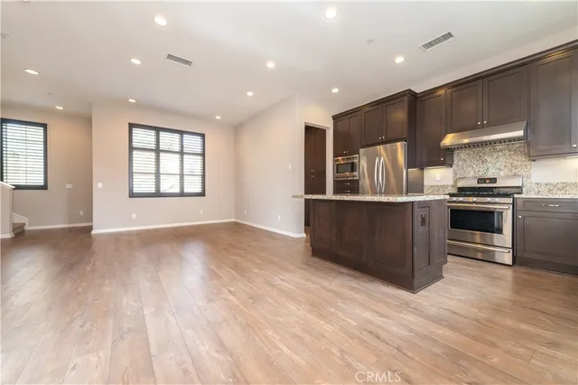 a bathroom with a granite countertop sink and a large mirror