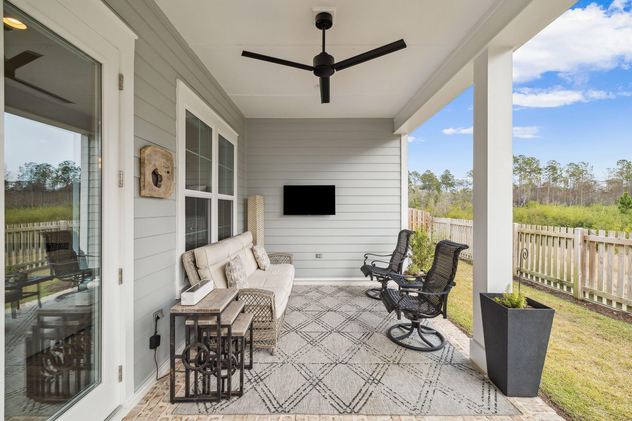 129 Suwannee Dr Inlet Beach Inlet Beach, FL 32461 - Photo 34 of 43 a living room with furniture a flat screen tv and a floor to ceiling window