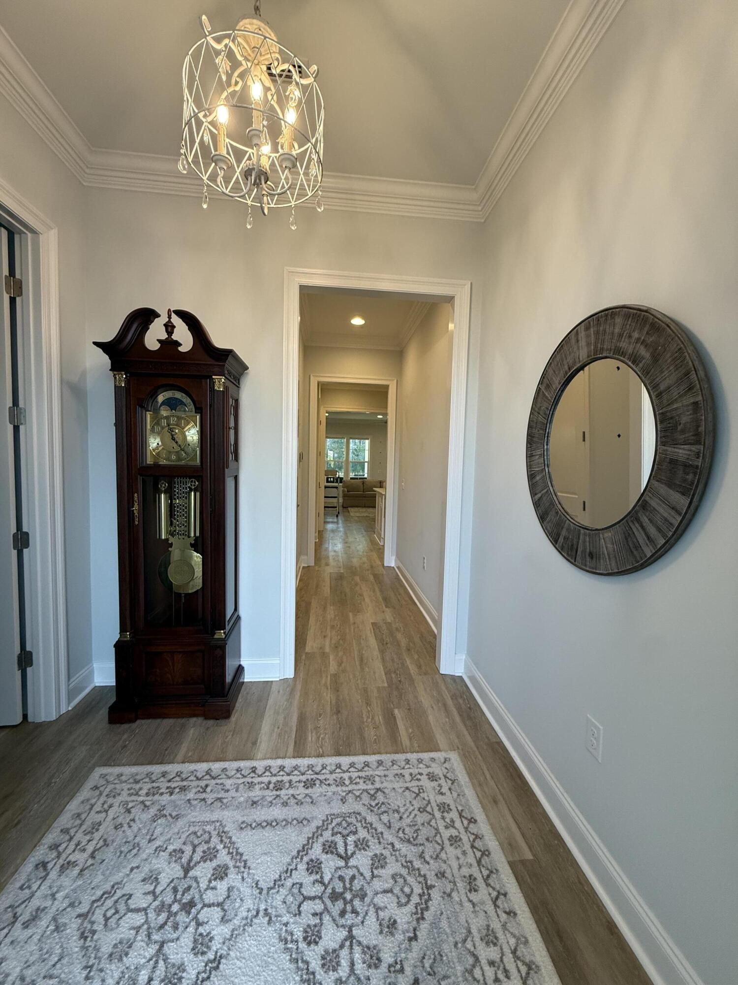 129 Suwannee Dr Inlet Beach Inlet Beach, FL 32461 - Photo 6 of 43 a view of a hallway with wooden floor and a chandelier