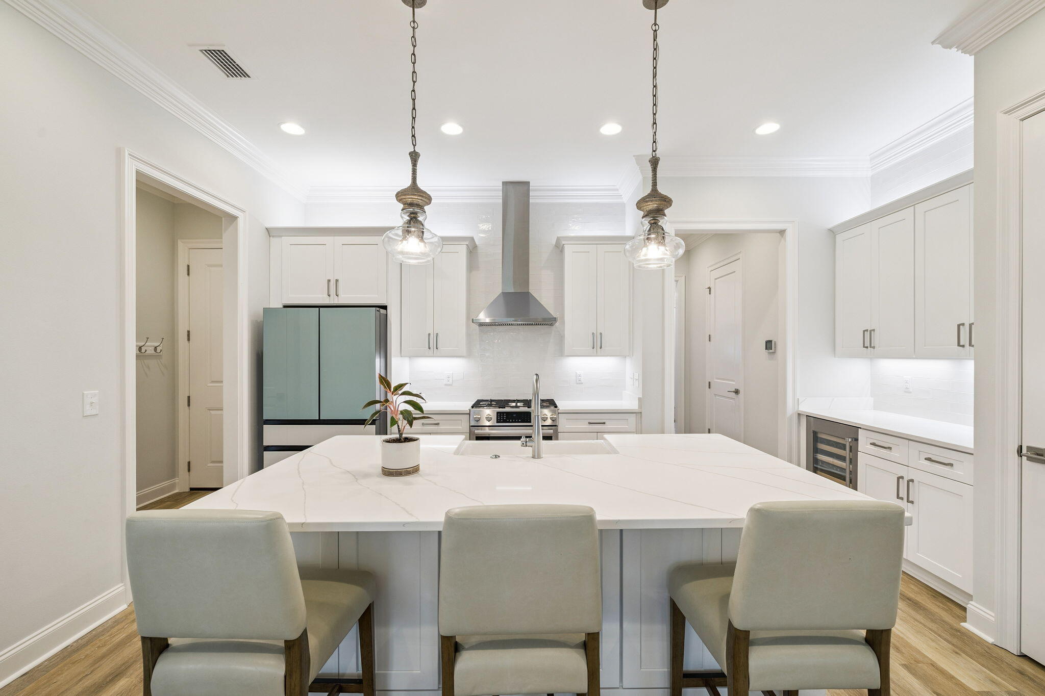 129 Suwannee Dr Inlet Beach Inlet Beach, FL 32461 - Photo 8 of 43 a kitchen with stainless steel appliances kitchen island granite countertop a dining table chairs and white cabinets