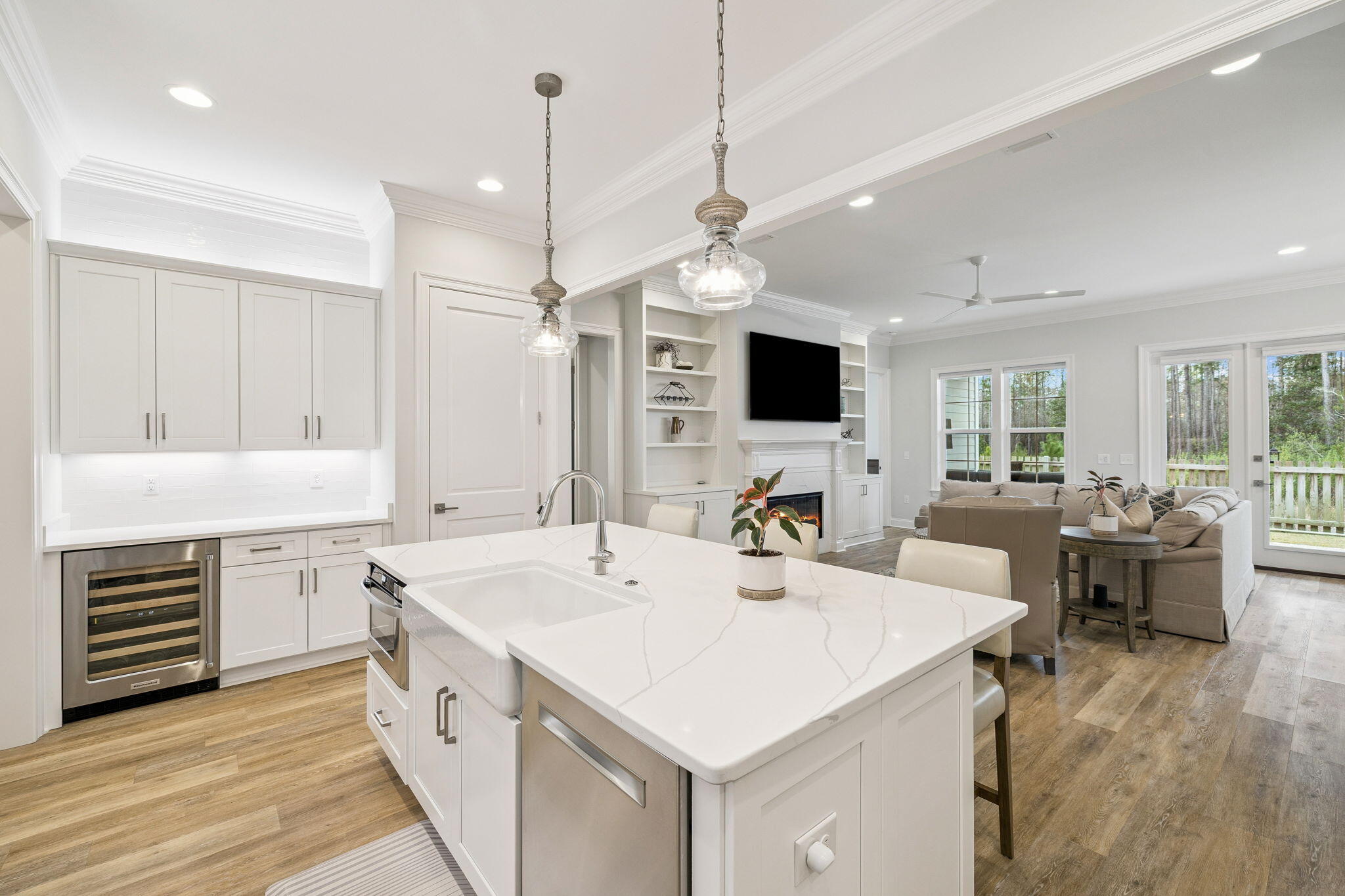 129 Suwannee Dr Inlet Beach Inlet Beach, FL 32461 - Photo 10 of 43 a large white kitchen with a stove a sink dishwasher a dining table and chairs with wooden floor