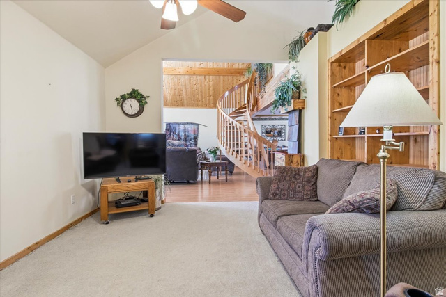 811 East Canyon Road Mayfield, UT 84643 - Photo 11 of 57 Vaulted ceiling living area featuring a built-in wood bookshelf, light-toned carpeting, and a visible wood spiral staircase