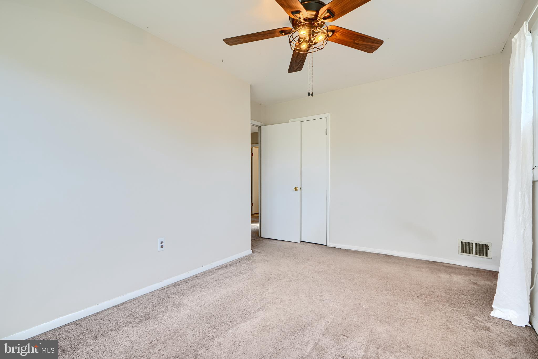 2 Haley Road Essex, MD 21221 - Photo 14 of 32 an empty room with a window and a fan