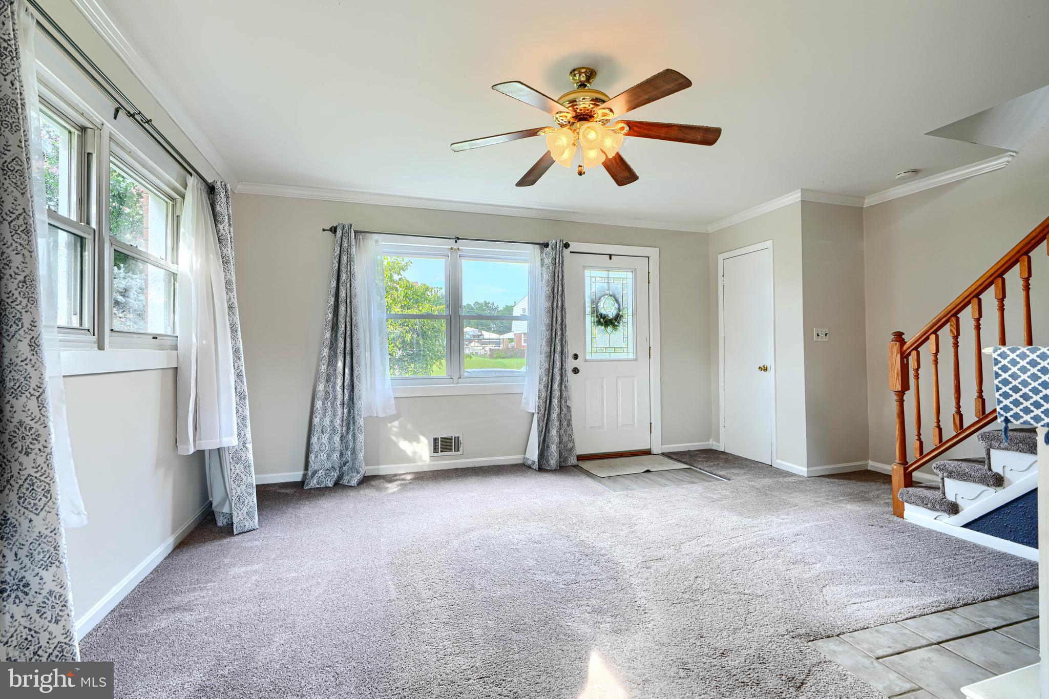 2 Haley Road Essex, MD 21221 - Photo 4 of 32 an empty room with windows and chandelier fan