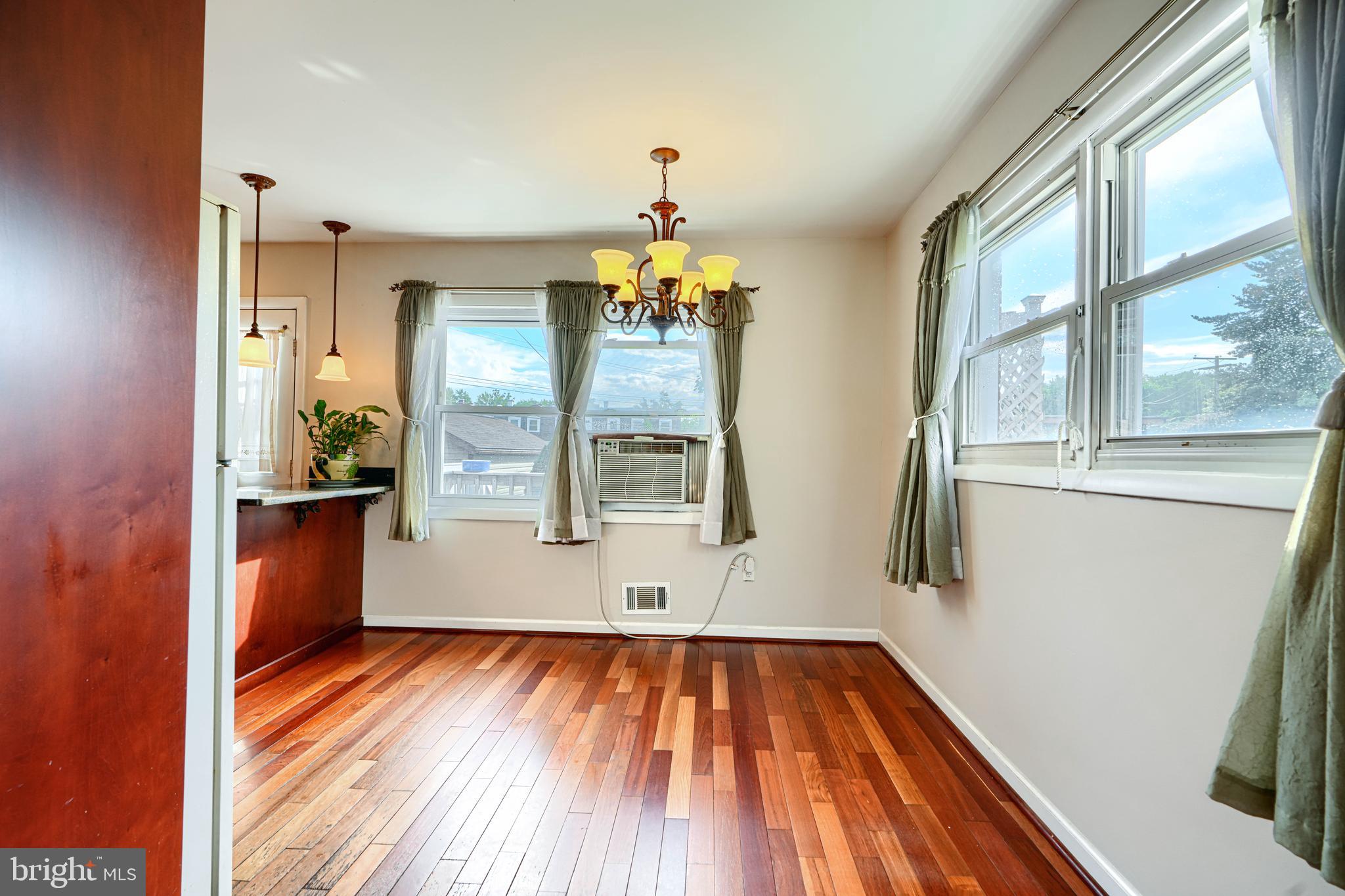 2 Haley Road Essex, MD 21221 - Photo 5 of 32 wooden floor in an empty room with a window