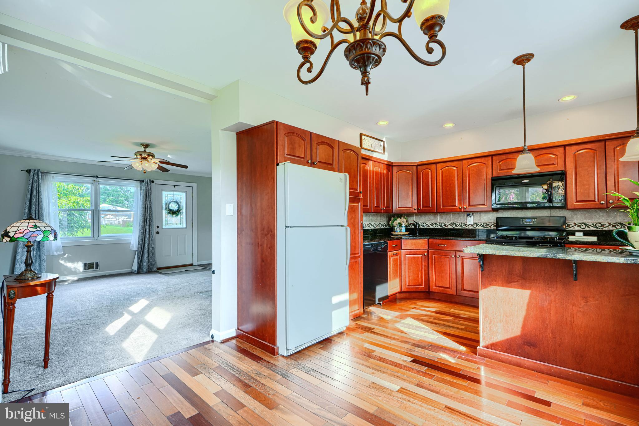 2 Haley Road Essex, MD 21221 - Photo 7 of 32 a kitchen with stainless steel appliances granite countertop a refrigerator a stove and a wooden floors