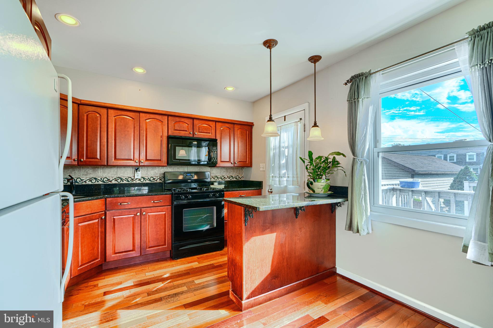 2 Haley Road Essex, MD 21221 - Photo 8 of 32 a kitchen with stainless steel appliances granite countertop a stove a sink and a refrigerator