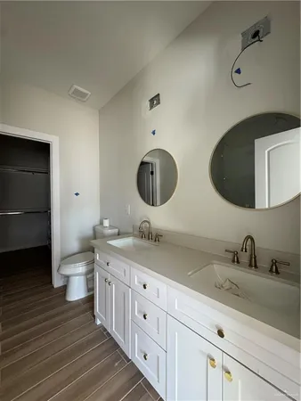 a bathroom with a double vanity sink and a mirror