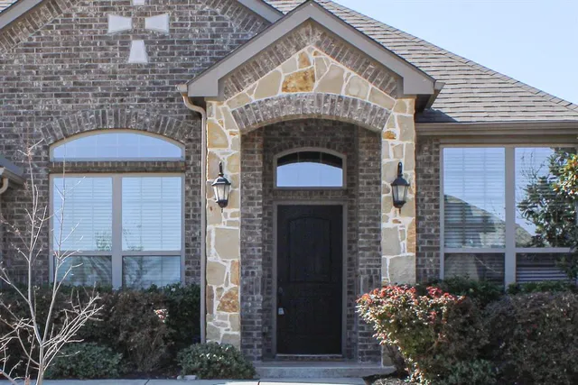a front view of a house with garden