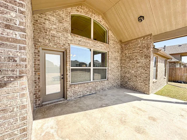a view of a wooden door of the house