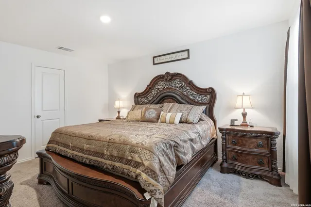a bedroom with a bed and a lamp on table