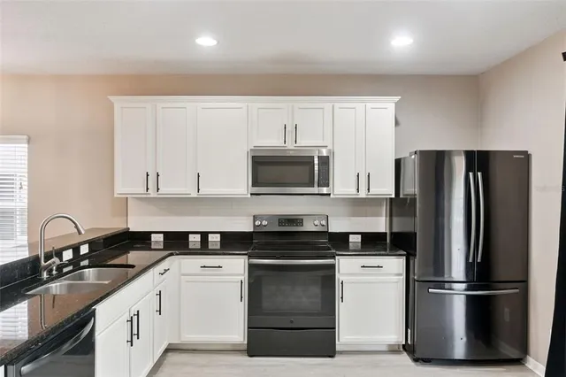 a kitchen with a sink stove and refrigerator