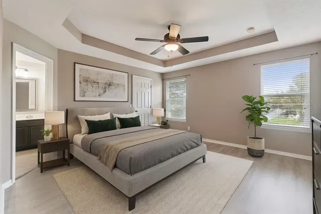 a spacious bedroom with a bed and a painting on the wall