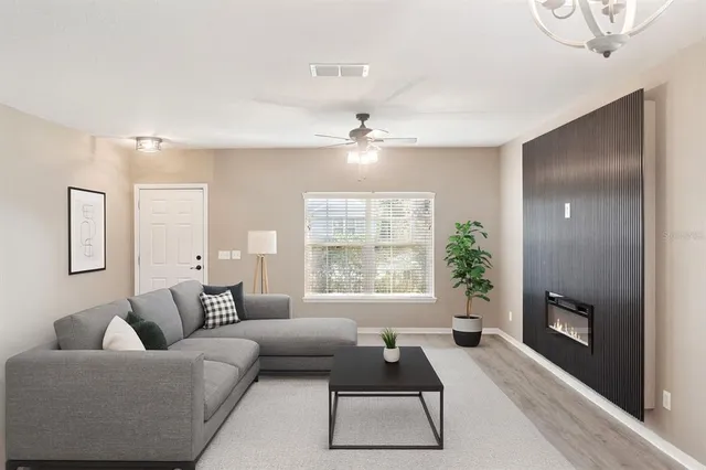 a living room with furniture and a large window