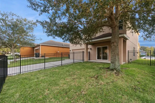 a view of a backyard with large trees