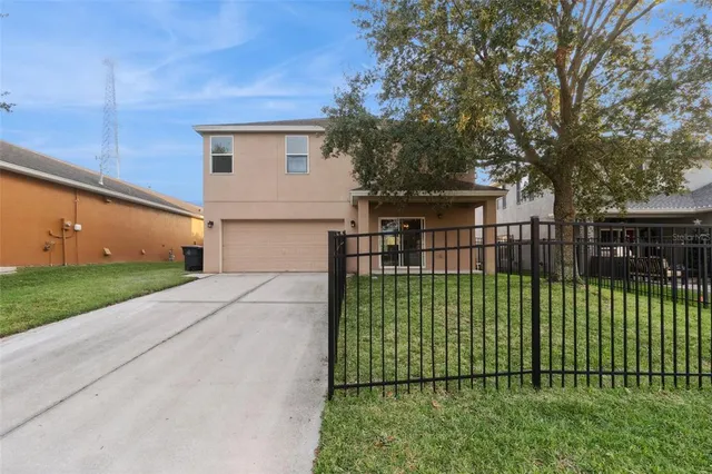 a view of a house with a small yard and plants