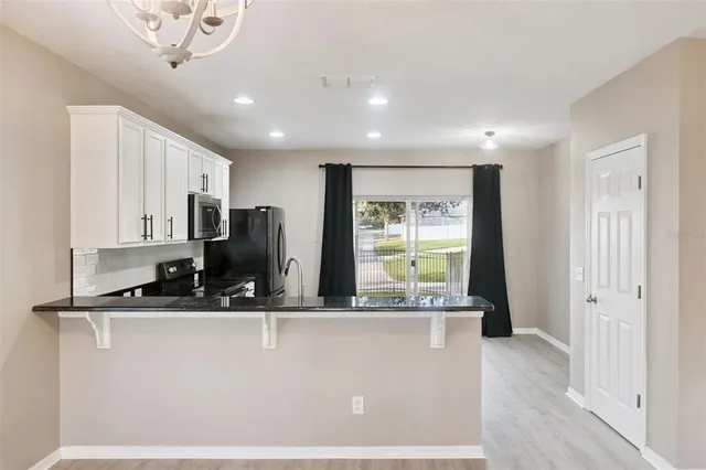 a view of kitchen with refrigerator sink and outdoor